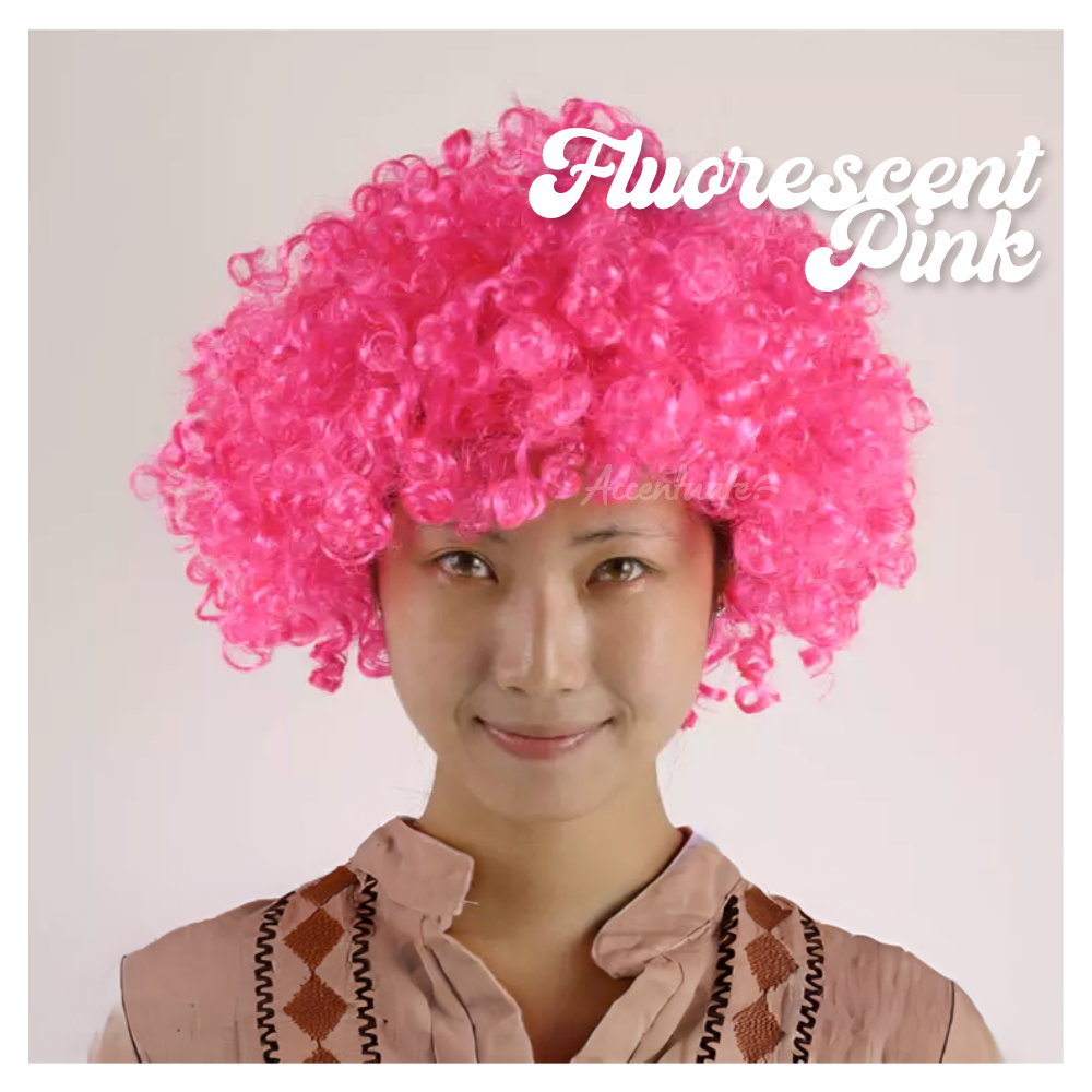 Person wearing a bright pink afro wig with 'Fluorescent Pink' text on a plain background